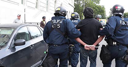 Protester being arrested by riot police.
