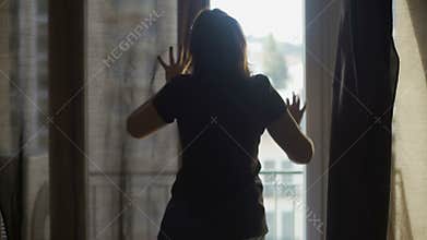 Female maid putting hotel room in order waiting for guests, cheap accommodation