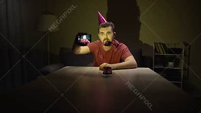 Sad bachelor celebrating birthday alone making selfie, depression, single life