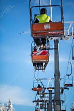 Ski lift with skiers being carried up the hill