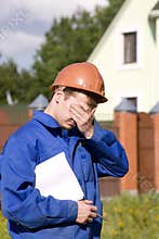 In a sad state working man in the helmet