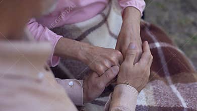 Man holding old female hands, family love and care, old couple in nursing home