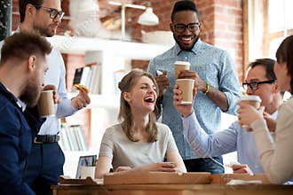 Happy diverse colleagues celebrate during lunch break in office