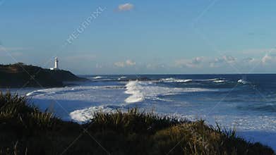 Lighthouse with large breaking surf