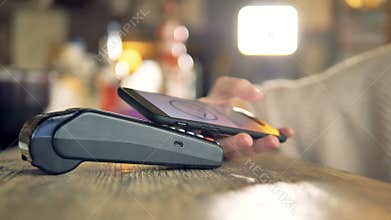 Payment made with smartphone using nfc system and contactless card.