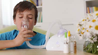 Boy using nebuliser inhaler - allergy and asthma concept