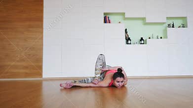 Young woman practicing advanced yoga poses.