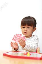 Japanese girl playing with boardgame