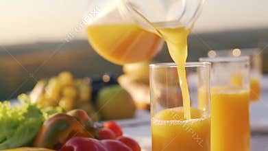 Orange juice is poured into a glass