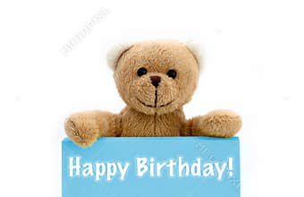 Happy Birthday blue card with brown teddy bear holding with the two hands the note with the message.