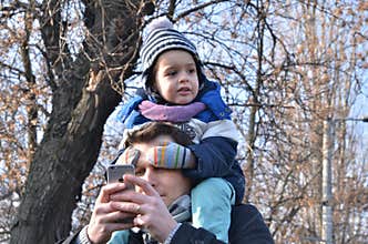 Boy sitting on fathers shoulders