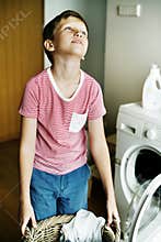 Kid helping house chores washing machine