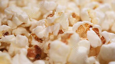 Fluffy popcorn macro, airy popped corn snack served at cinema, entertainment