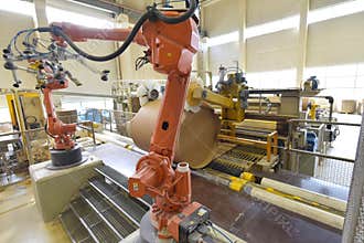 Industrial robot in a paper mill - automation in a modern plant