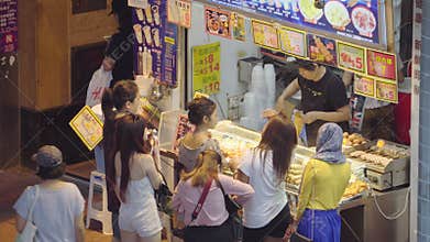 4k video of people buying street food at food stall in Hong Kong