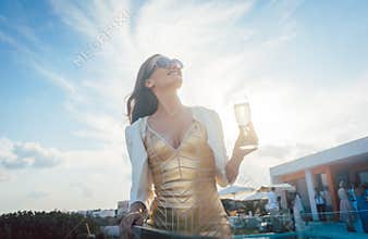 Woman having champagne at summer party