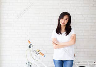 Portrait of beautiful young asian woman happiness standing on gray cement texture grunge wall brick background.