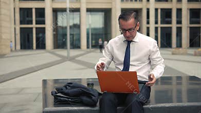 Businessman getting bad news on his laptop