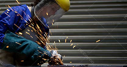 Female welder using grinder in workshop 4k