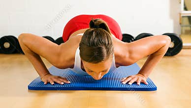 Woman doing pushups in gym