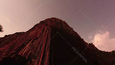 Dramatic high rock columns view up with starry night background