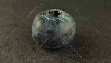 One round blueberry on a rotating table. Sweet blueberries for making raw jam. Cooking concept. Healthy food.