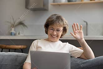 Happy old 60s retired woman holding video call.