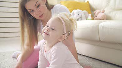 Concept of hearing impairment and their treatment. Cute little girl with a Cochlear implant