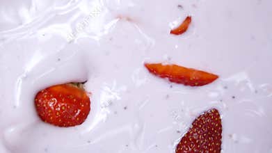 Ripe red strawberry mixed with yogurt slow motion video