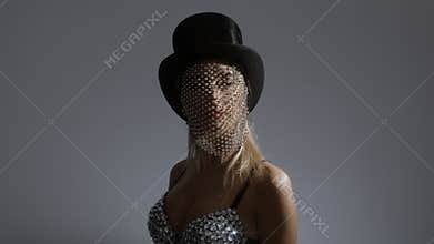 Young woman wearing top hat with sparkly veil and bustier