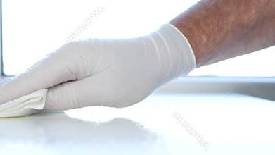 Close Up Man Hands with White Gloves Cleanse Furniture Surface Using Sprayed Cleaning Liquid