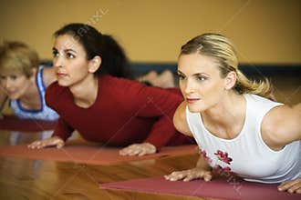 Adult females in yoga class.