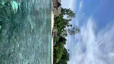 Lagoon With Huts On Ocean Beach In Kaimana Island. Vertical Video Of Turquoise Sea And Picturesque Tropical Resort With Bungalows