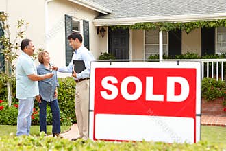 Senior Hispanic couple buying new home