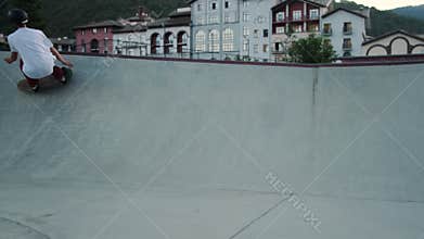 skateboarding in special park, sportsman is riding skateboard in city park
