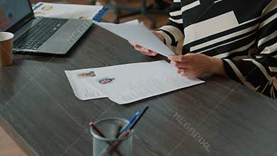 Female HR employee looking at cv resume to hire candidates