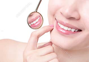 Healthy woman teeth and a dentist mouth mirror