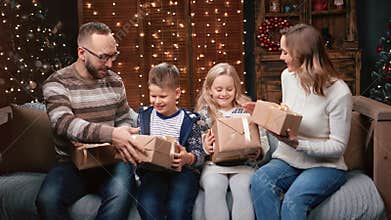 Joyful family exchanging Christmas gifts to each other celebrate holiday. 4k Dragon RED camera