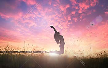 Freedom concept of woman jumping and broken chains