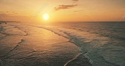 Slow motion of ocean waves at sun set light aerial view. Sunset wavy seascape at tropical paradise