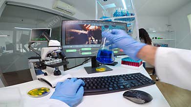 POV of scientist doctor doing research checking liquid from chemical container