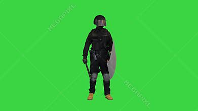 Riot police man with tactical baton and a shield standing and touching his face on a Green Screen, Chroma Key.