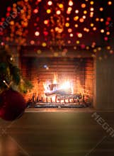 Xmas at home. Red ball on tree branch, bokeh burning fireplace background. Copy space