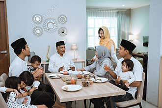 beautiful asian family enjoying their iftar dinner at home