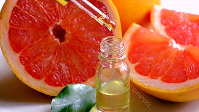 Grapefruit essential oil in a small bottle. Selective focus.