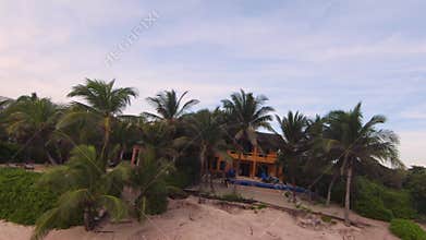 Aerial slow motion of scenic Mexican beachfront homes and resorts