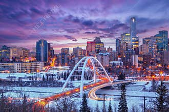 Winter blue hour sunset skyline of Edmonton, Canada, with light trails from rush hour traffic across Walterdale Bridge