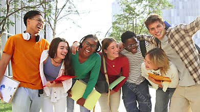 Big group of real students smiling and looking at camera together at high school. Happy teenagers laughing at university