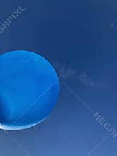 closeup of isolated blue baloon against blue sky