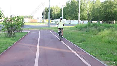 Woman Riding a Bicycle on a Platform in a Park